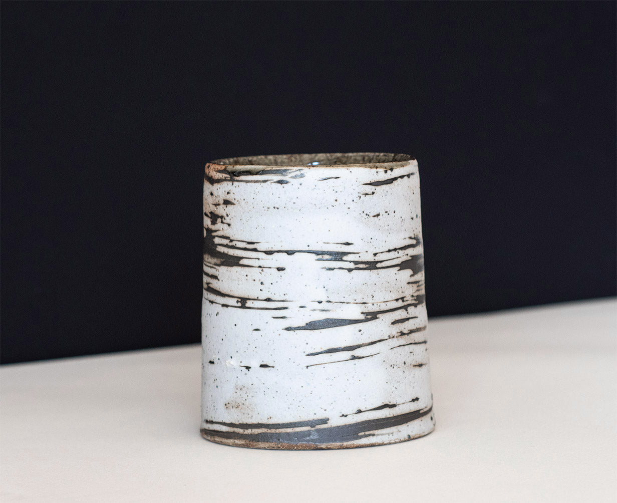 A ceramic tumbler that resemble thin birch trees, were thrown for us by the amazing David Ernster, fired in his wood kiln at his home studio in New Hampshire.